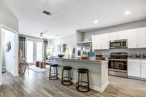 a kitchen with a counter and stools